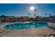 Community pool area featuring multiple covered lounge spaces, mature landscaping, and clear blue water at 9302 E Broadway Rd # 157, Mesa, AZ 85208