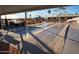 Community shuffleboard courts with covered seating, landscaping, and tall palm trees at 9302 E Broadway Rd # 157, Mesa, AZ 85208