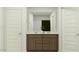 Bathroom featuring double sinks with wooden cabinetry and a large mirror at 9526 W Catalina Dr, Phoenix, AZ 85037