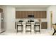 Bright kitchen boasts stainless steel appliances, breakfast bar with seating, and plentiful cabinet space at 9526 W Catalina Dr, Phoenix, AZ 85037
