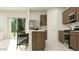 Well-appointed kitchen featuring an island with seating and modern stainless steel appliances at 9526 W Catalina Dr, Phoenix, AZ 85037
