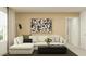 Bright living room features a white sofa, modern decor, and a large window at 9526 W Catalina Dr, Phoenix, AZ 85037