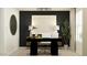 Modern office space with sleek black desk, decorative lighting, and stylish accents creating an inspiring work environment at 9526 W Catalina Dr, Phoenix, AZ 85037