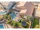 Aerial shot showcases a backyard oasis with a pool, spa, pergola, trampoline, and mature trees at 1015 E Constitution Dr, Gilbert, AZ 85296