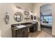 Bathroom with dual sinks, granite counters, and round mirrors at 1015 E Constitution Dr, Gilbert, AZ 85296