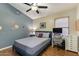 Cozy bedroom featuring planet themed decor, hardwood floors, and ample natural light at 1015 E Constitution Dr, Gilbert, AZ 85296