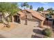 Beautiful two-story home showcasing a tile roof, manicured landscaping, and an attached three-car garage at 1015 E Constitution Dr, Gilbert, AZ 85296