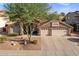 Charming home with a well-maintained lawn, desert landscaping, and a convenient three-car garage at 1015 E Constitution Dr, Gilbert, AZ 85296