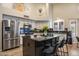 Stylish kitchen with stainless steel appliances, granite countertops, an island with bar seating at 1015 E Constitution Dr, Gilbert, AZ 85296
