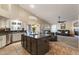 Open-concept kitchen featuring a center island, modern appliances, and seamless transition into the living area at 1015 E Constitution Dr, Gilbert, AZ 85296
