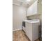 Well-lit laundry room with modern washer and dryer, plus overhead cabinets for storage at 1015 E Constitution Dr, Gilbert, AZ 85296