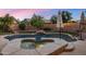 Backyard pool with a spa, waterfall, and beautiful landscaping at 1015 E Constitution Dr, Gilbert, AZ 85296