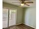 Bedroom featuring a ceiling fan, neutral paint, vinyl floors, and access to the patio at 10201 N 97Th Ave # B, Peoria, AZ 85345