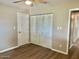 Bedroom with a ceiling fan, vinyl floors, and closet for storage at 10201 N 97Th Ave # B, Peoria, AZ 85345