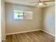 Bedroom featuring a ceiling fan, neutral paint, window and vinyl floors at 10201 N 97Th Ave # B, Peoria, AZ 85345