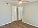 Bedroom featuring a ceiling fan, neutral paint, closet, and vinyl floors at 10201 N 97Th Ave # B, Peoria, AZ 85345