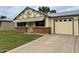 Charming single-story home with a brick accent wall and a well-manicured front lawn and a single car garage at 10201 N 97Th Ave # B, Peoria, AZ 85345