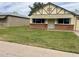 Charming single-story home with a brick accent wall and a well-manicured front lawn at 10201 N 97Th Ave # B, Peoria, AZ 85345