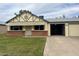 Charming single-story home with a brick accent wall and a well-manicured front lawn and a single car garage at 10201 N 97Th Ave # B, Peoria, AZ 85345