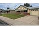 Charming single-story home with a brick accent wall and a well-manicured front lawn and a single car garage at 10201 N 97Th Ave # B, Peoria, AZ 85345