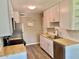 Modern kitchen featuring butcher block countertops and white cabinets at 10201 N 97Th Ave # B, Peoria, AZ 85345