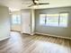 Bright living room with wood flooring and two windows at 10201 N 97Th Ave # B, Peoria, AZ 85345