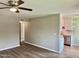 Bright living room featuring modern ceiling fan and stylish wood-look flooring at 10201 N 97Th Ave # B, Peoria, AZ 85345