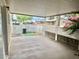 Covered patio area with concrete flooring, white lattice fencing, and flower landscaping at 10201 N 97Th Ave # B, Peoria, AZ 85345