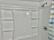 Walk-in shower with white surround and new shower head at 10201 N 97Th Ave # B, Peoria, AZ 85345