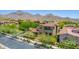 Beautiful aerial view of a home with lush landscaping, mountains and red tile roof at 10287 E Diamond Rim Dr, Scottsdale, AZ 85255