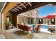 Inviting backyard patio with pool views, comfortable seating, and lush landscaping at 10287 E Diamond Rim Dr, Scottsdale, AZ 85255