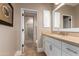 Bright bathroom with tan marble countertops, white cabinetry, and walk-in shower with glass door at 10287 E Diamond Rim Dr, Scottsdale, AZ 85255