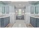 Luxurious bathroom featuring dual vanities, marble countertops, arched doorways, and mosaic tile floors at 10287 E Diamond Rim Dr, Scottsdale, AZ 85255