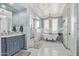Elegant bathroom with a freestanding tub, walk-in shower, dual vanities, neutral colors, and modern fixtures at 10287 E Diamond Rim Dr, Scottsdale, AZ 85255