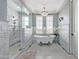 Elegant bathroom with a freestanding tub, walk-in shower, dual vanities, neutral colors, and modern fixtures at 10287 E Diamond Rim Dr, Scottsdale, AZ 85255