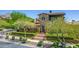 Charming two-story home with stone accents, red tiled roof, manicured landscaping, and mountain views at 10287 E Diamond Rim Dr, Scottsdale, AZ 85255