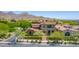 Stunning view of the home with a tile roof nestled in the desert landscape and mountain views at 10287 E Diamond Rim Dr, Scottsdale, AZ 85255