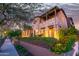 Stunning home with stone accents, balcony, and beautiful outdoor lighting at 10287 E Diamond Rim Dr, Scottsdale, AZ 85255