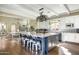 Spacious kitchen with a large island, ample seating, and stainless-steel appliances at 10287 E Diamond Rim Dr, Scottsdale, AZ 85255