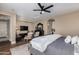 Spacious main bedroom featuring a dark wood dresser, ceiling fan, and access to another room, providing a comfortable and functional space at 10287 E Diamond Rim Dr, Scottsdale, AZ 85255
