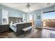 Light-filled bedroom with French doors to a balcony, neutral color palette, wooden floors, and sophisticated furnishings at 10287 E Diamond Rim Dr, Scottsdale, AZ 85255