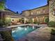 Backyard pool with stone patio surrounded by manicured landscaping offers a serene retreat at 10287 E Diamond Rim Dr, Scottsdale, AZ 85255