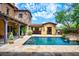 Luxurious backyard featuring a private pool, custom patio, and multiple seating areas at 10287 E Diamond Rim Dr, Scottsdale, AZ 85255