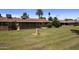 Expansive backyard featuring a covered patio and well-maintained lawn, perfect for outdoor relaxation and entertainment at 10325 W Prairie Hills Cir, Sun City, AZ 85351
