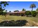 Spacious backyard featuring a screened-in porch and lush greenery at 10325 W Prairie Hills Cir, Sun City, AZ 85351