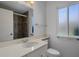 Modern bathroom featuring a vanity with a large mirror, a shower with glass doors, and natural light at 10325 W Prairie Hills Cir, Sun City, AZ 85351