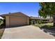 Charming single-story home with a two-car garage and well-maintained landscaping at 10325 W Prairie Hills Cir, Sun City, AZ 85351