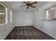Bright, carpeted living room featuring a ceiling fan and connecting to the kitchen at 10325 W Prairie Hills Cir, Sun City, AZ 85351