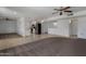 Spacious open-concept living area with tile and carpet, connecting to the kitchen at 10325 W Prairie Hills Cir, Sun City, AZ 85351