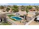 Aerial view of a home with sparkling pool and outdoor lounge area at 1036 S 75Th St, Mesa, AZ 85208